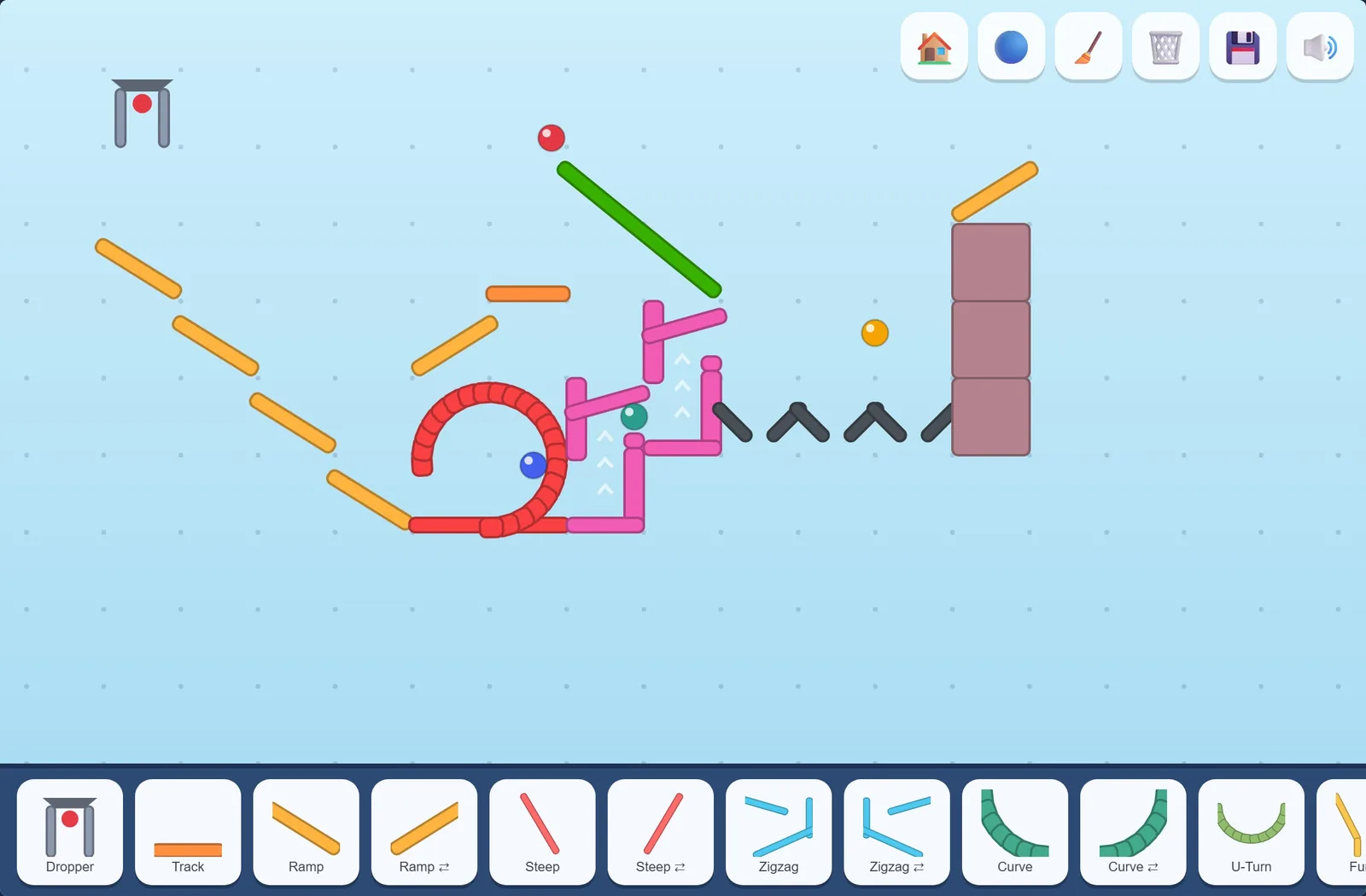 The Round & Round track mid-run: marbles in the loop, rising on the lift, and in the air past the cannons.